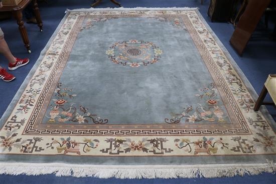 A Chinese pale blue ground carpet, with a cream foliate embossed border 365cm x 273cm